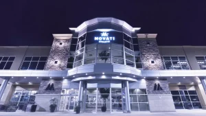 MOVATI Athletic building illuminated at night, marking the Guelph & Brantford Anniversary celebration.