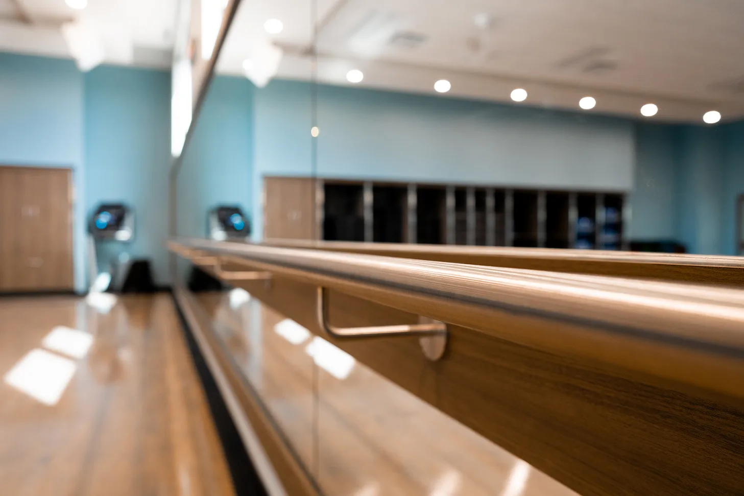 Dance studio with mirrors and barre, ideal for practicing dance warm ups and improving flexibility and mobility.