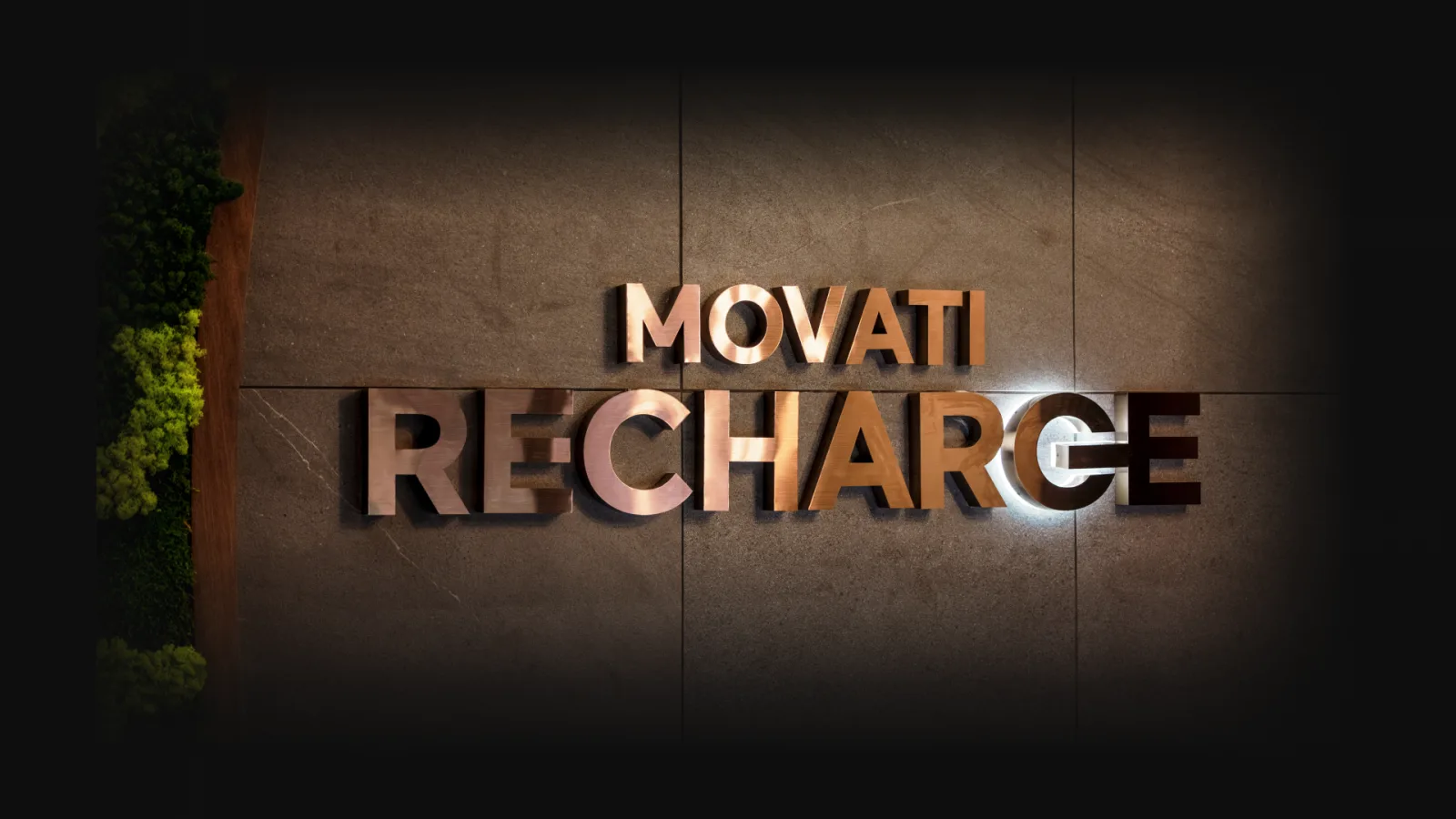 "Movati Recharge sign on a wall, highlighting DOMS recovery solutions post-workout."