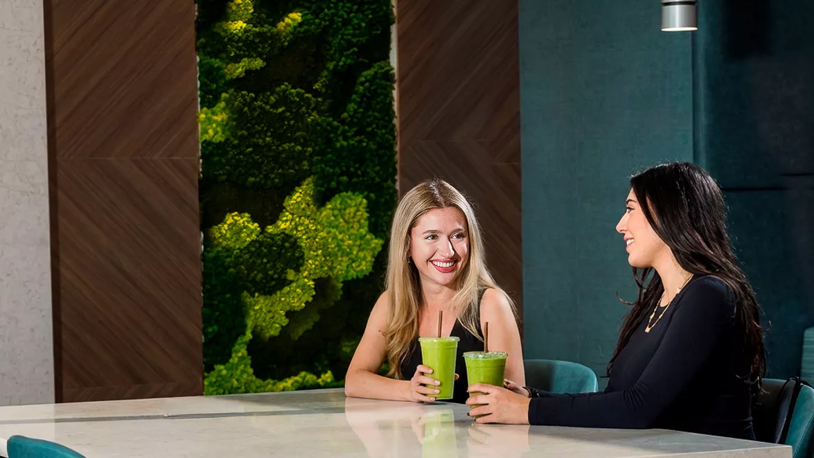 People enjoying smoothies, highlighting essential nutrients like proteins, carbohydrates, and fats for health and energy.