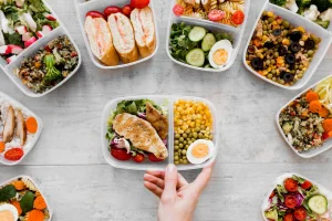 Meal prep containers with grilled chicken, roasted vegetables, and herbs, ideal for healthy meals for dinner.