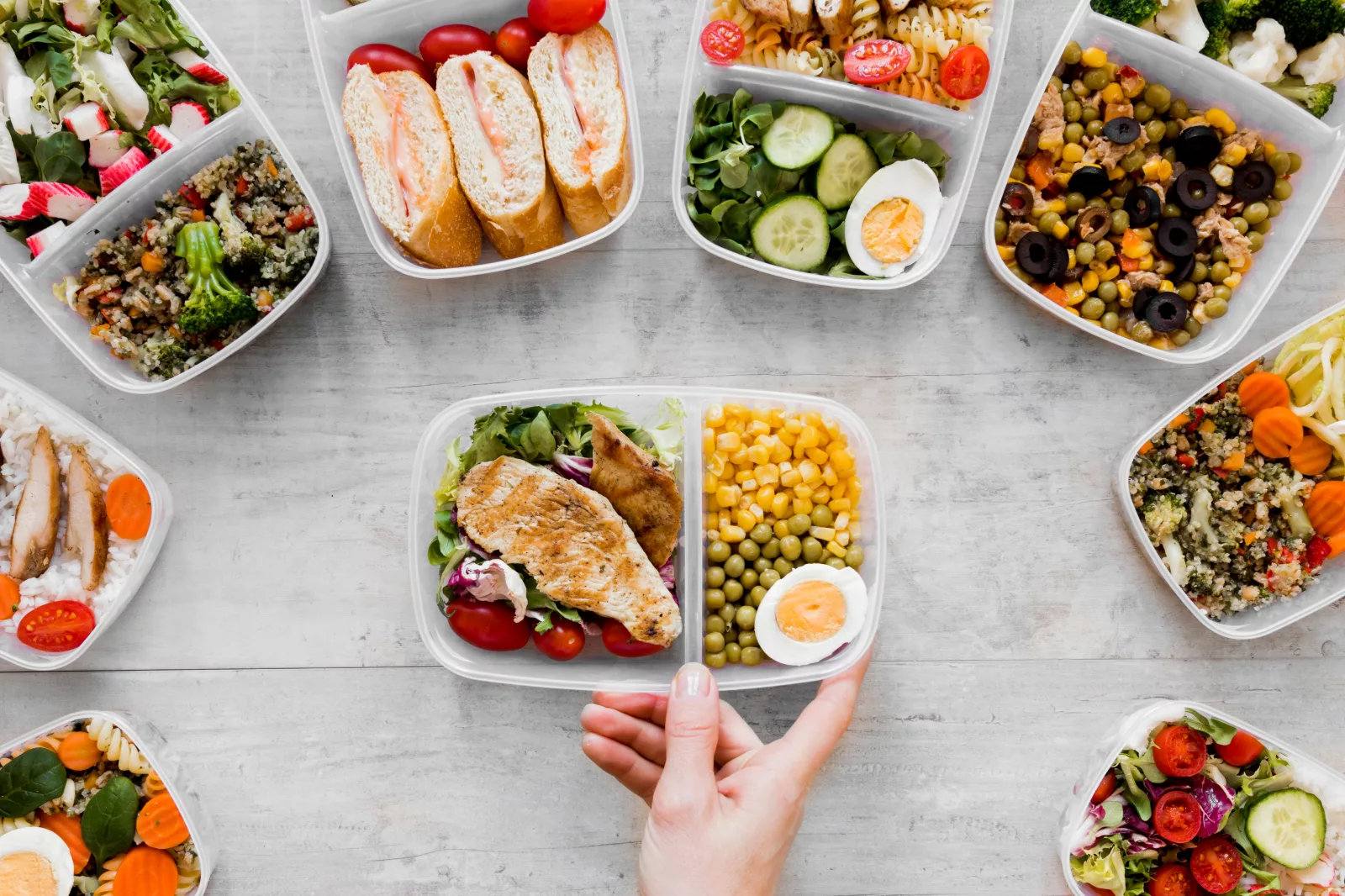 Meal prep containers with grilled chicken, roasted vegetables, and herbs, ideal for healthy meals for dinner.