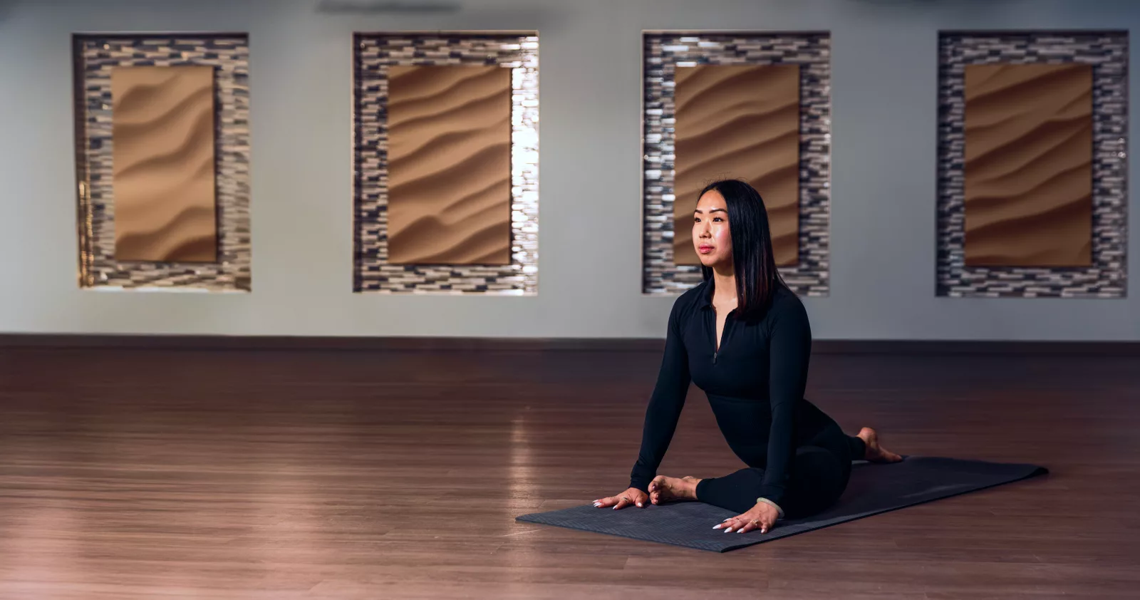 Person practicing yoga indoors, showcasing the latest yoga trends in a serene studio setting.