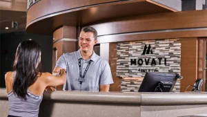 Receptionist greeting a member at Movati, showcasing friendly life at Movati.