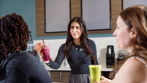 Two women enjoying smoothies, highlighting nutrition for better energy with a vibrant, healthy lifestyle focus.