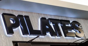Pilates studio sign highlighting the benefits of pilates for runners.