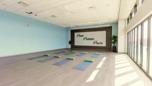 Yoga studio with mats and bolsters arranged for a yoga for stress relief class, enhancing mental and physical well-being.